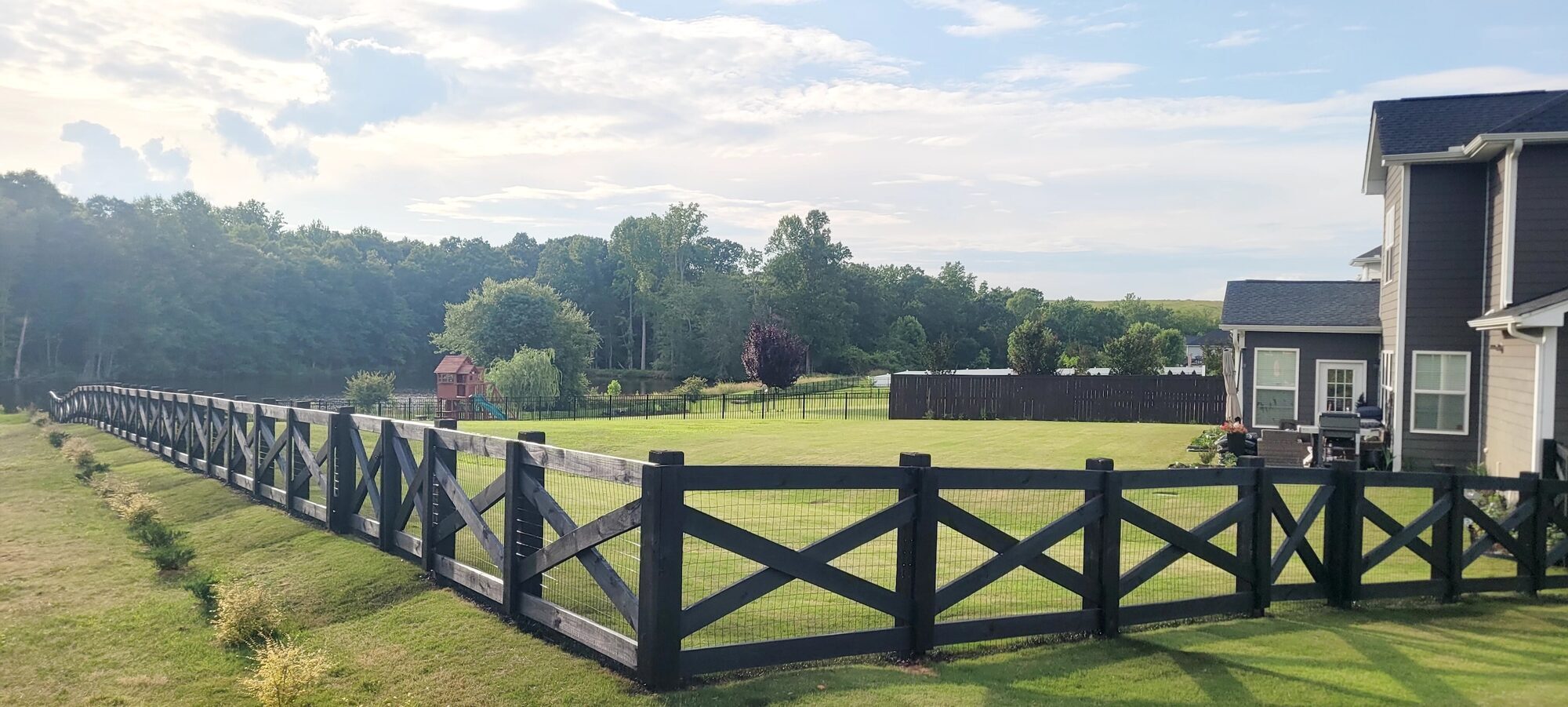 The same fence stained a deep, solid black